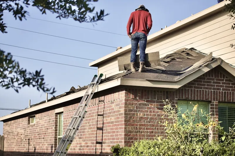 Professional roofer working on a residential roof in Kentland